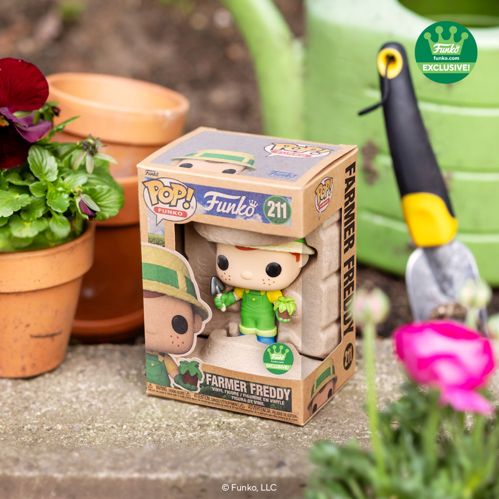 Pop! Farmer Freddy inside his earthy looking box, surrounded by plants in a garden.